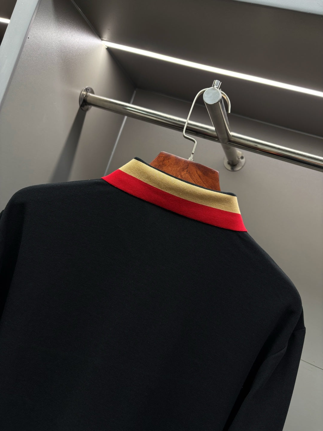 Polo shirt back neckline with red and gold striped collar trim