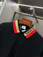 Black long-sleeve polo shirt with striped collar facing and buttoned placket