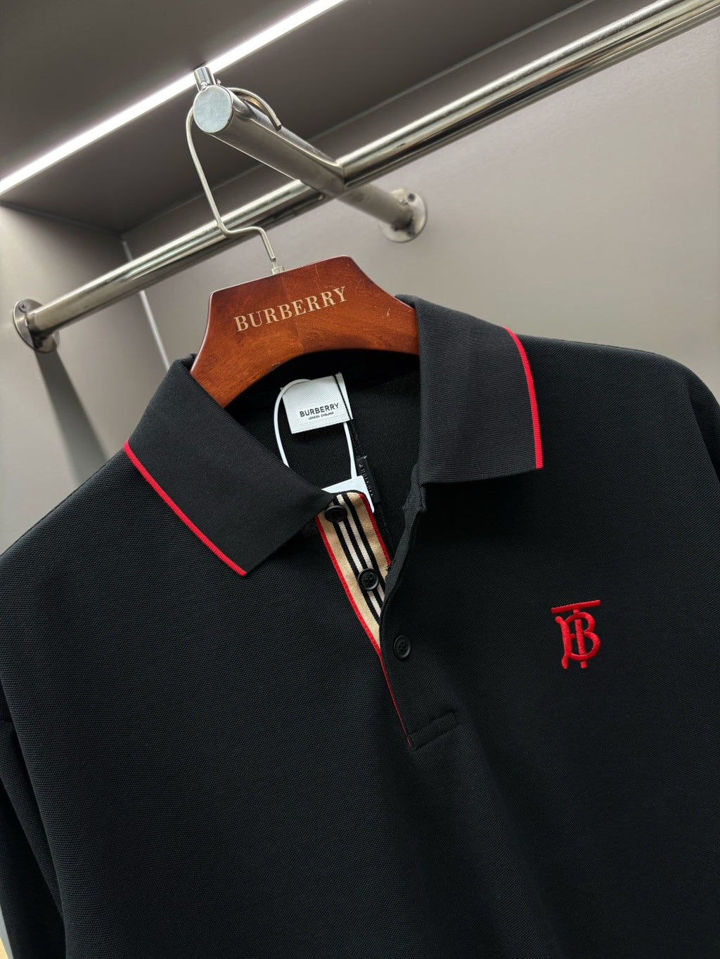 Long-sleeve polo shirt with red-trim collar and monogram logo on chest