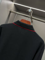 Long-sleeve polo shirt close-up: red-trim collar and shoulder seam