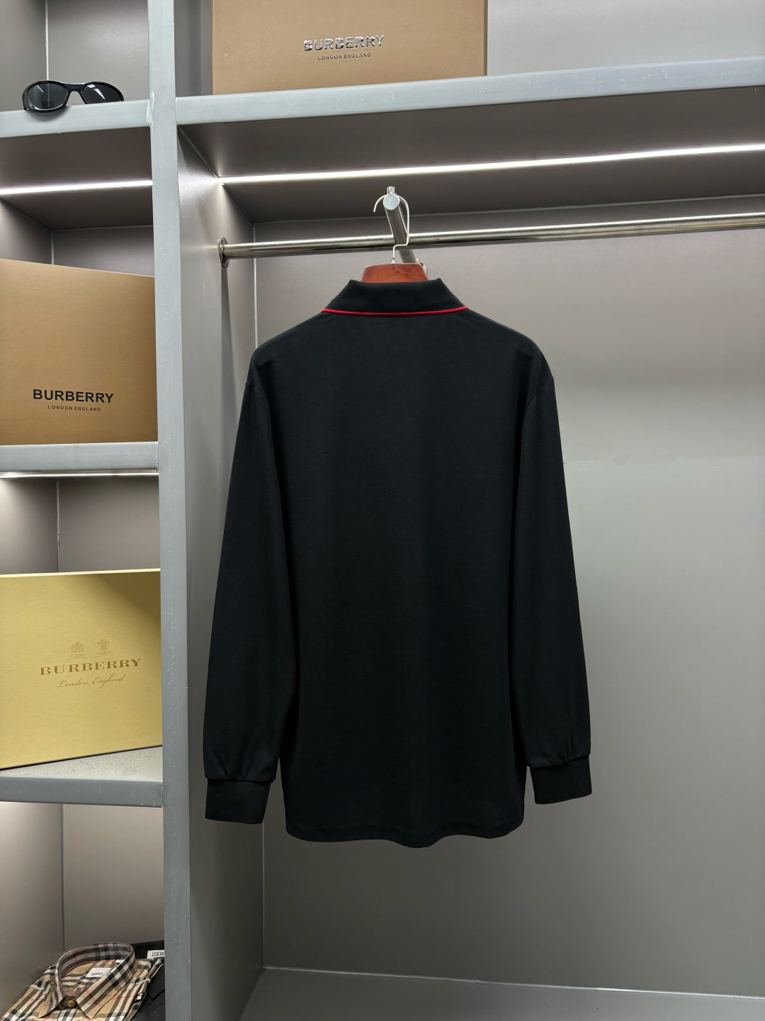 Long-sleeve polo shirt full back view in dark black, unpatterned