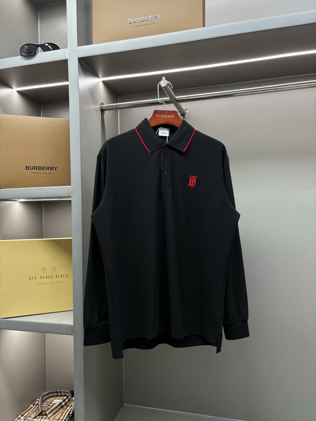 Long-sleeve polo shirt in dark black with red-trim collar and chest monogram logo