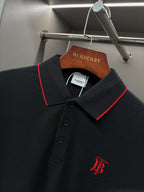 Long-sleeve polo shirt collar close-up with red trim, buttons, and monogram logo