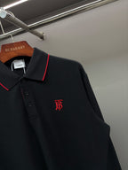 Long-sleeve polo shirt close-up: red-trim collar and front monogram logo