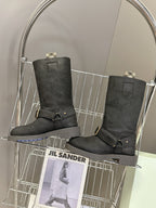 Pair of black suede tall boots with side buckle strap and stacked heel