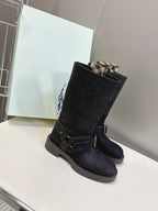 Black suede mid-calf boots with buckled strap and low lug sole
