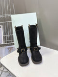 Pair of black suede ankle boots with side buckle and short stacked heel