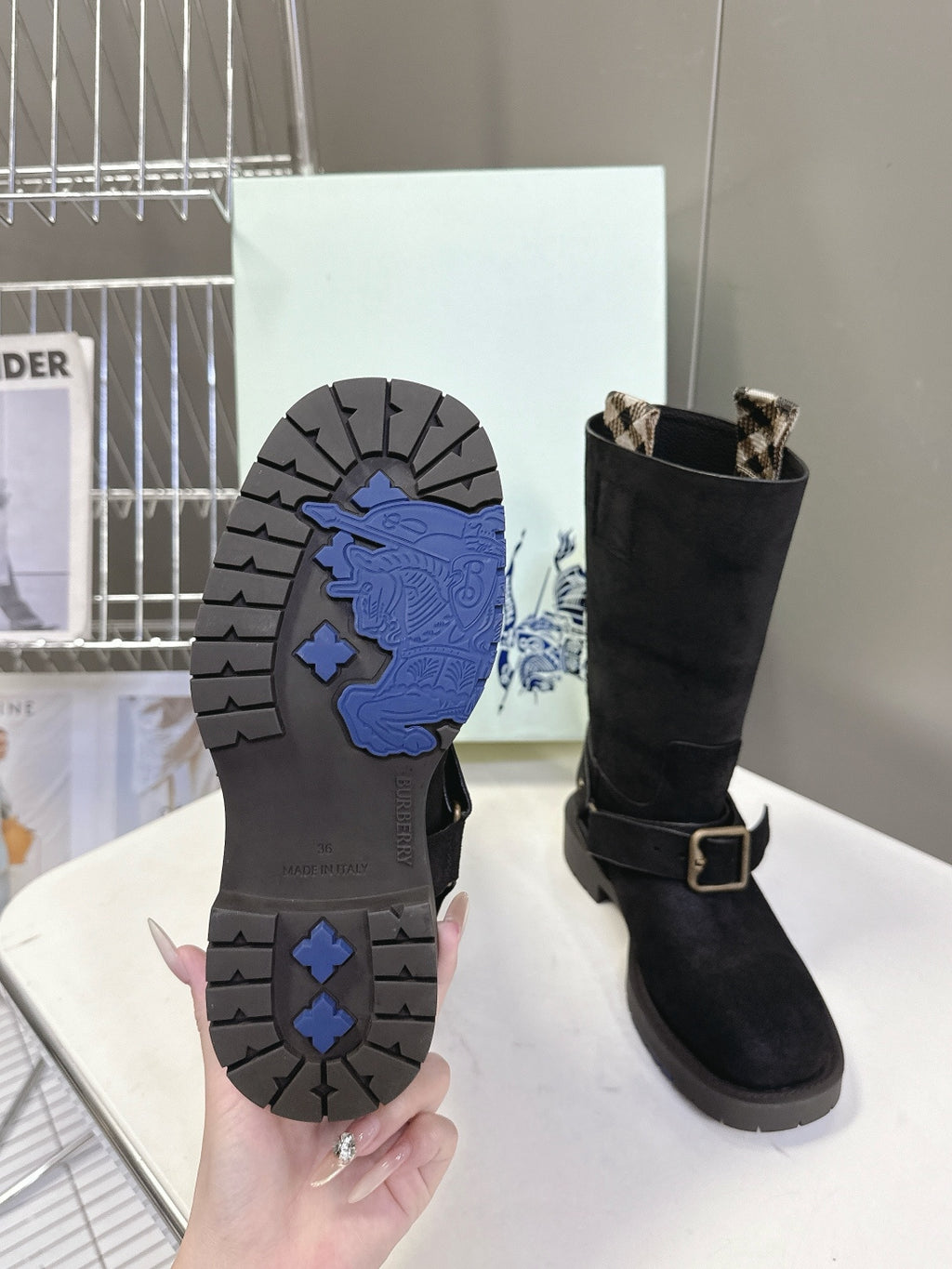 Black boot outsoles with blue tread pattern and dark rubber sole