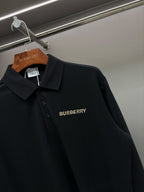 Black Burberry long-sleeve polo shirt front close-up with chest logo