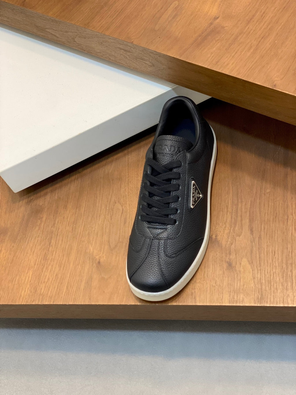 Prada unisex low-top sneakers, dark leather lace-up, textured panels, white sole