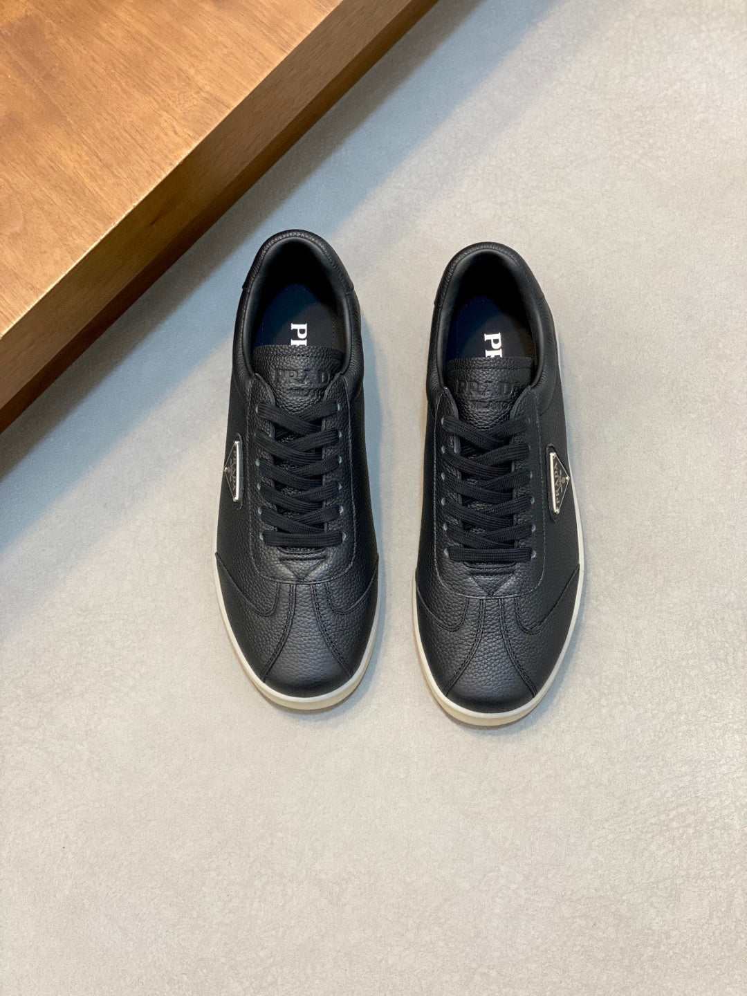 Prada unisex low-top sneakers, dark navy leather, lace-up with white rubber sole