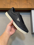 Prada unisex low-top sneakers, dark leather upper, lace-up, white sole, side logo