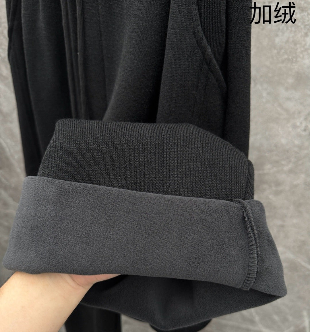 Dark grey sweatpants cuff and hem detail with ribbed inner lining