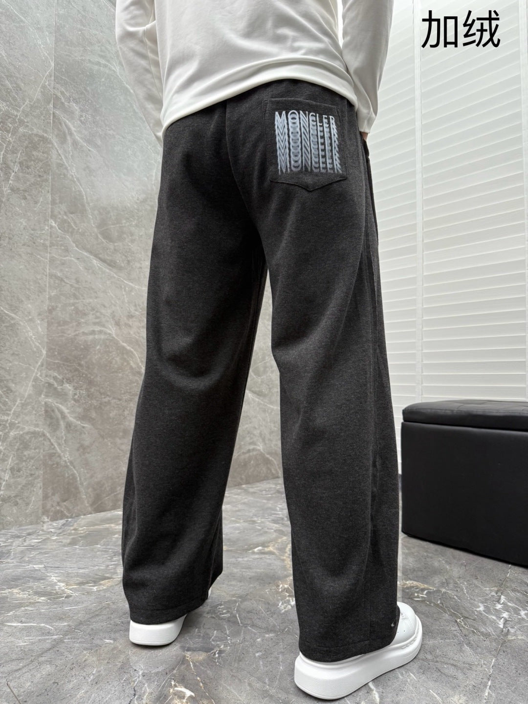 Black sweatpants with side pocket logo patch and ribbed cuffs