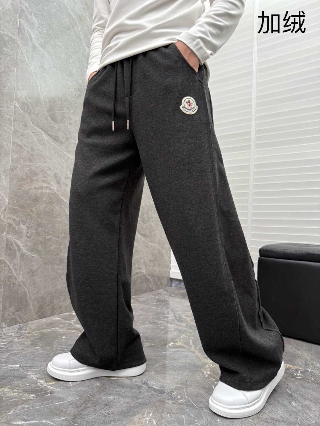 Black jogger pants with drawstring, relaxed straight leg, designer logo patch