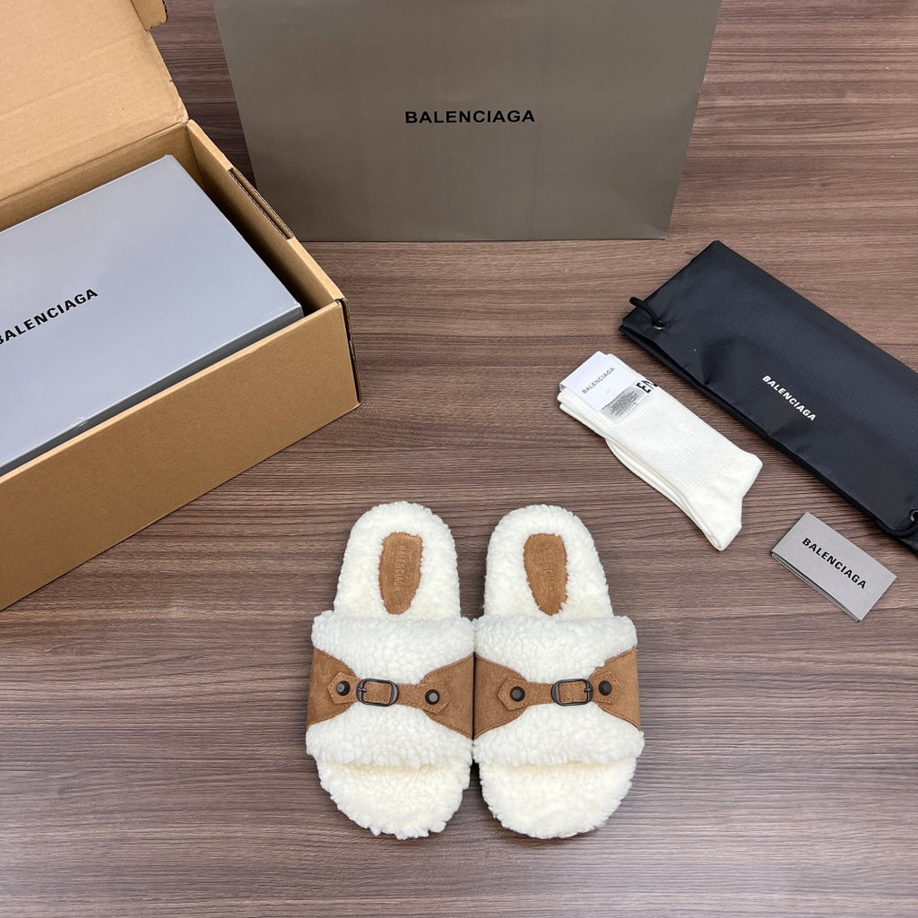 Fuzzy white Balenciaga sandals with tan buckled straps and oval cutouts