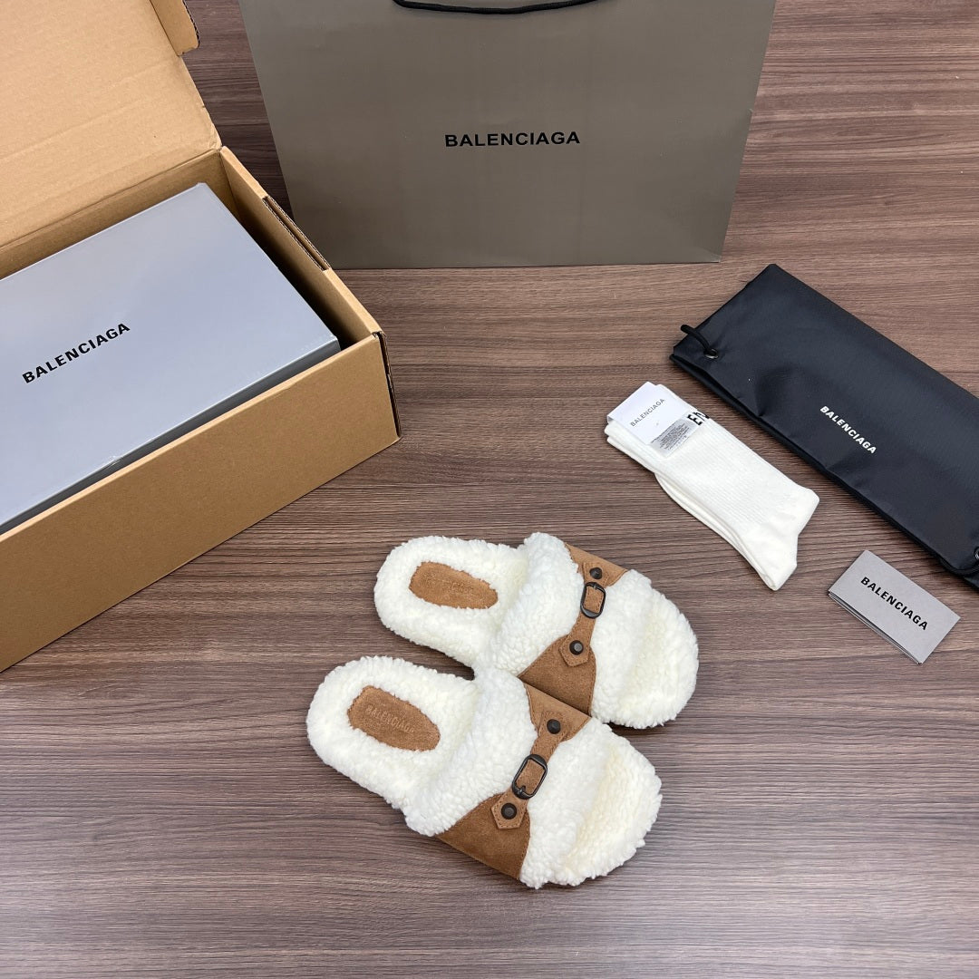 Cream plush Balenciaga slide sandals with tan buckled straps and oval toe openings