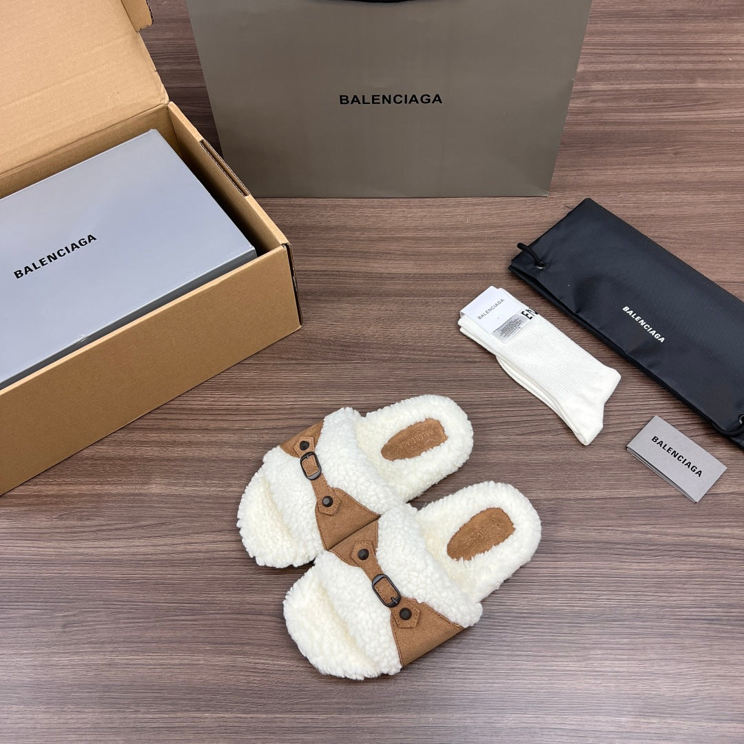 White teddy Balenciaga sandals with tan strap panel and buckle accents, angled view