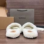 Close-up of white plush Balenciaga sandals with tan oval toe panels and straps