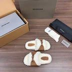 White plush Balenciaga sandals with tan cross straps and buckle details, pair view