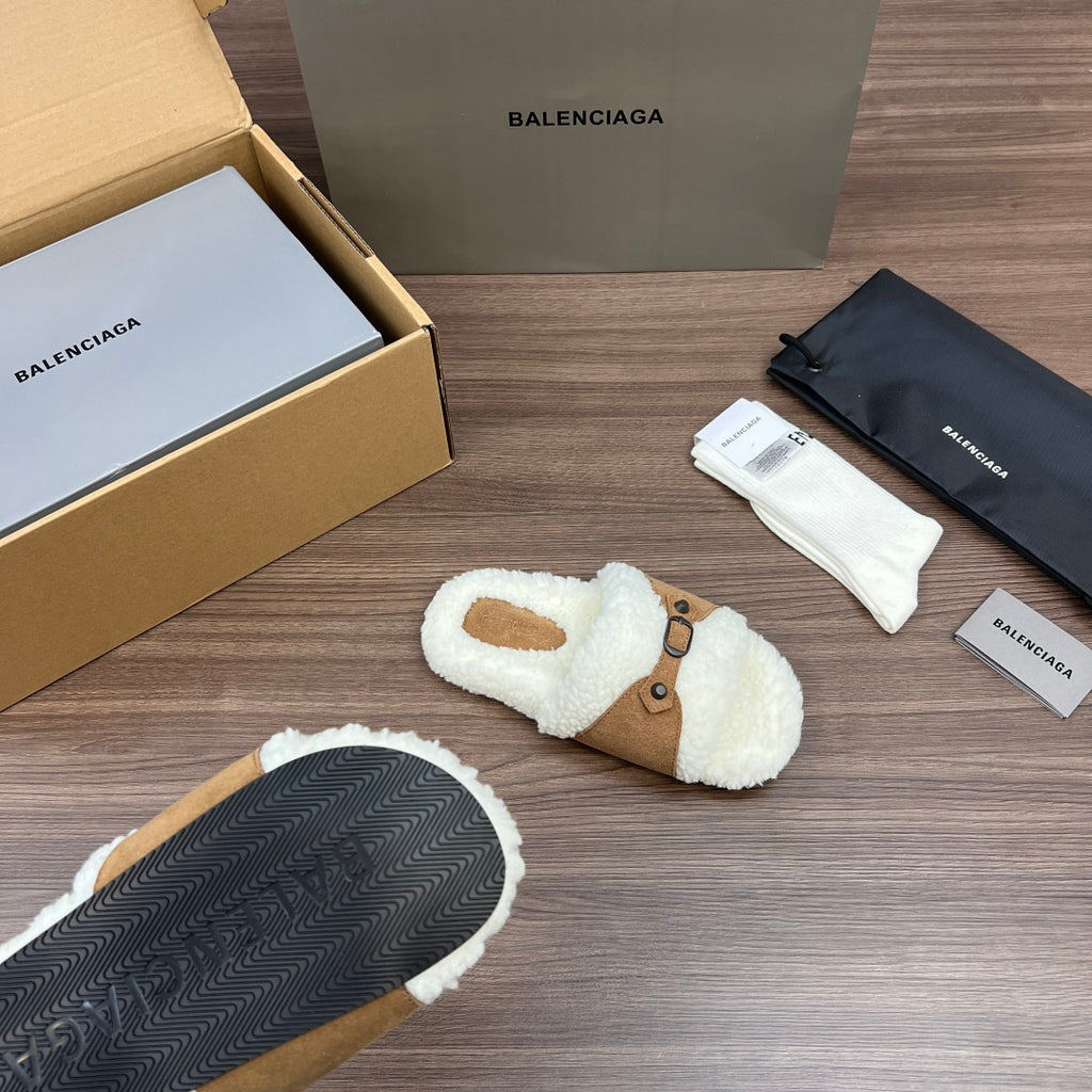 White plush Balenciaga slide sandals with tan straps; dark textured outsole visible