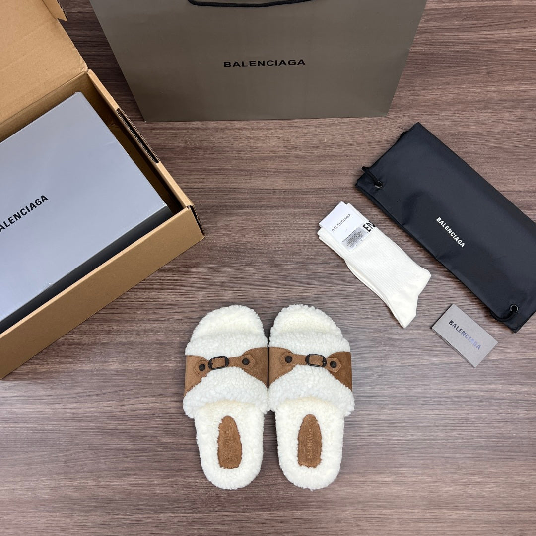 Cream plush Balenciaga slide sandals with tan strap panel and buckles, front view