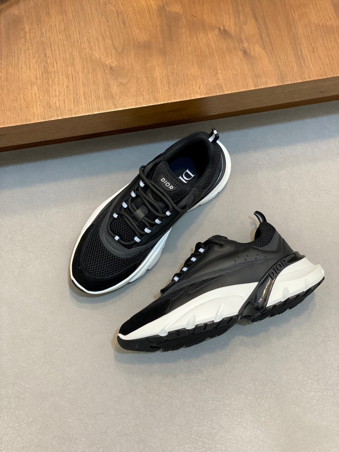 Black Dior sneakers with white soles and perforated panels, viewed from above