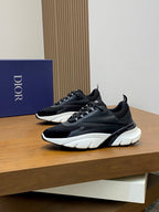 Black Dior sneakers with white midsoles and chunky tread, side view on display