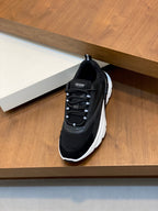 Black Dior lace-up sneakers with white rubber sole, front view on display