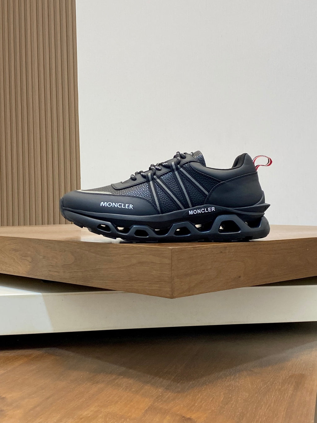 Moncler dark sneakers with MONCLER side branding and molded tread sole