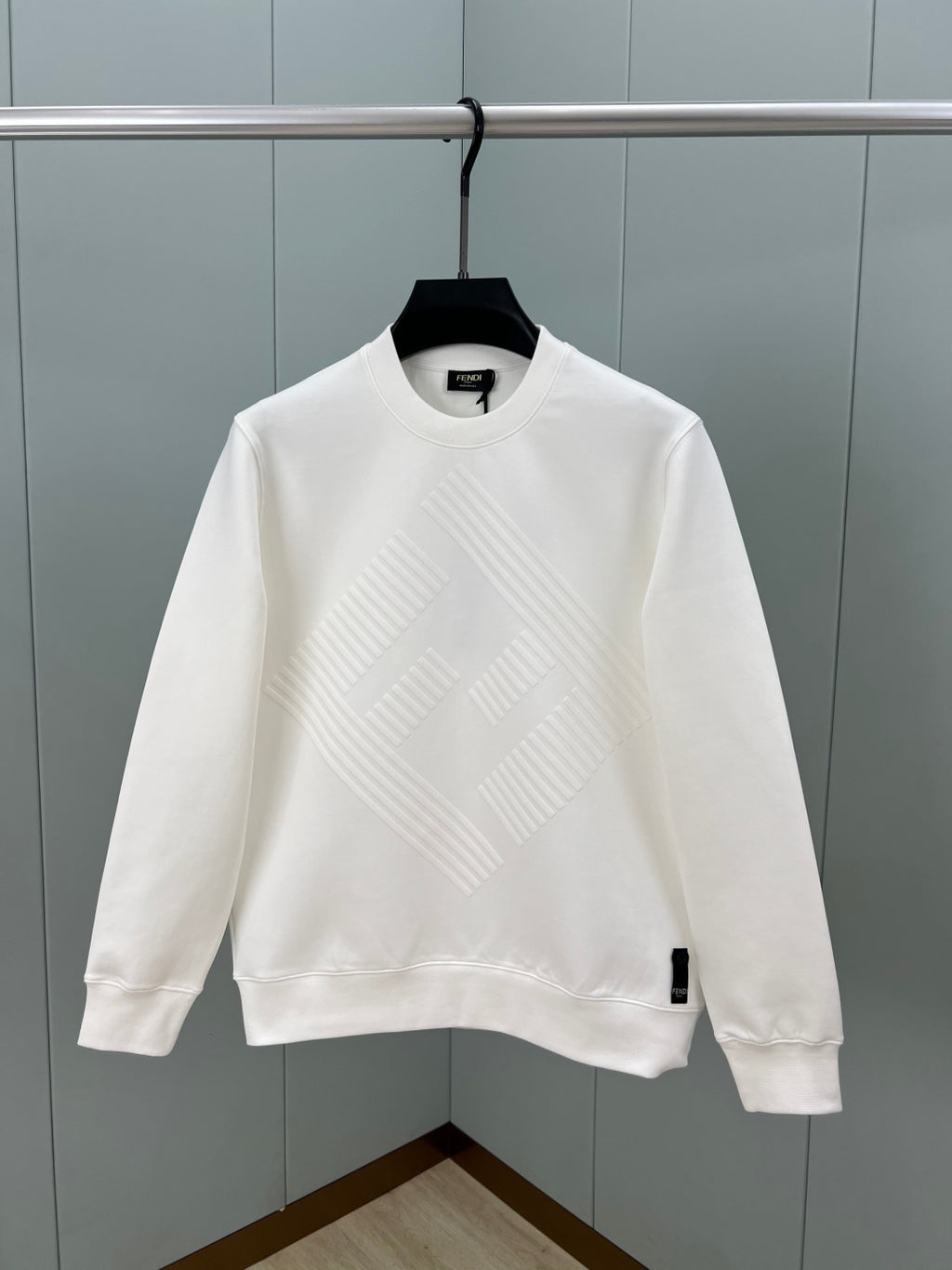 White Fendi sweatshirt with raised diagonal logo pattern and ribbed crew neck