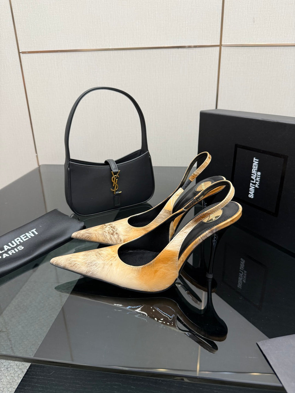 Women’s pointed-toe slingback heels and black handbag set with gold logo hardware