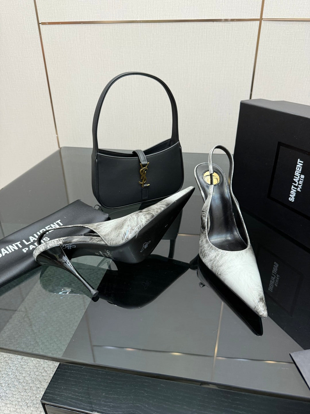 YSL ladies pointed-toe stiletto heels, black and silver metallic, side view