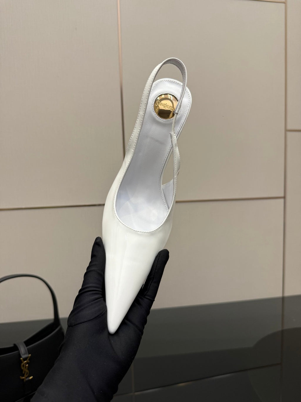 White slingback pump shoe with pointed toe and small heel opening, close-up