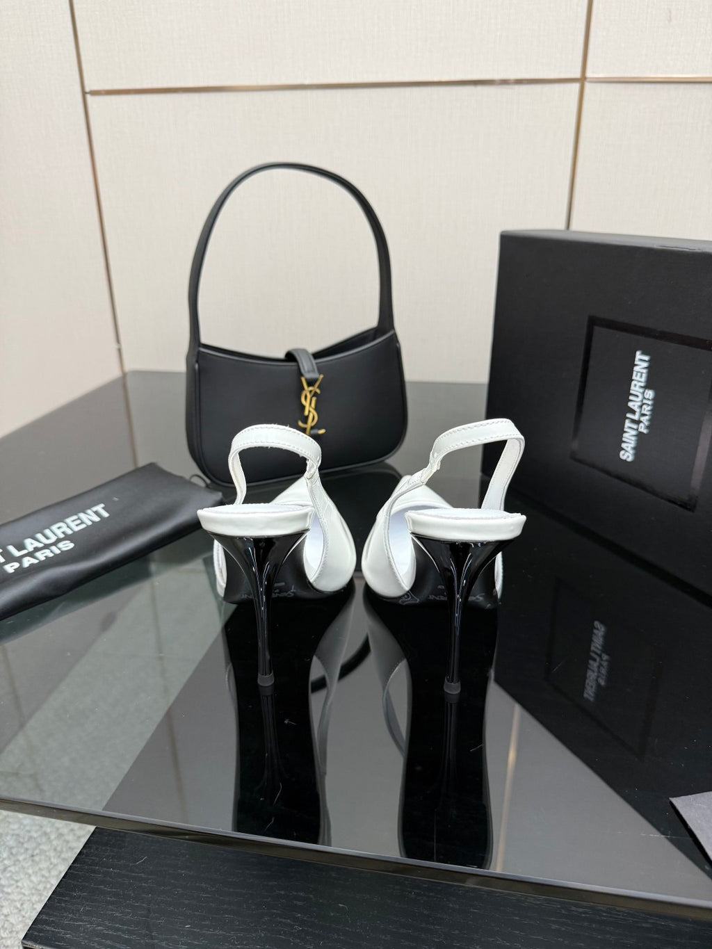 Black pointed-toe stiletto heels with ankle strap and slim heel