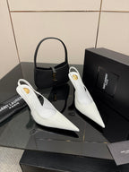 White pointed-toe slingback stiletto heels on display, slim high heel