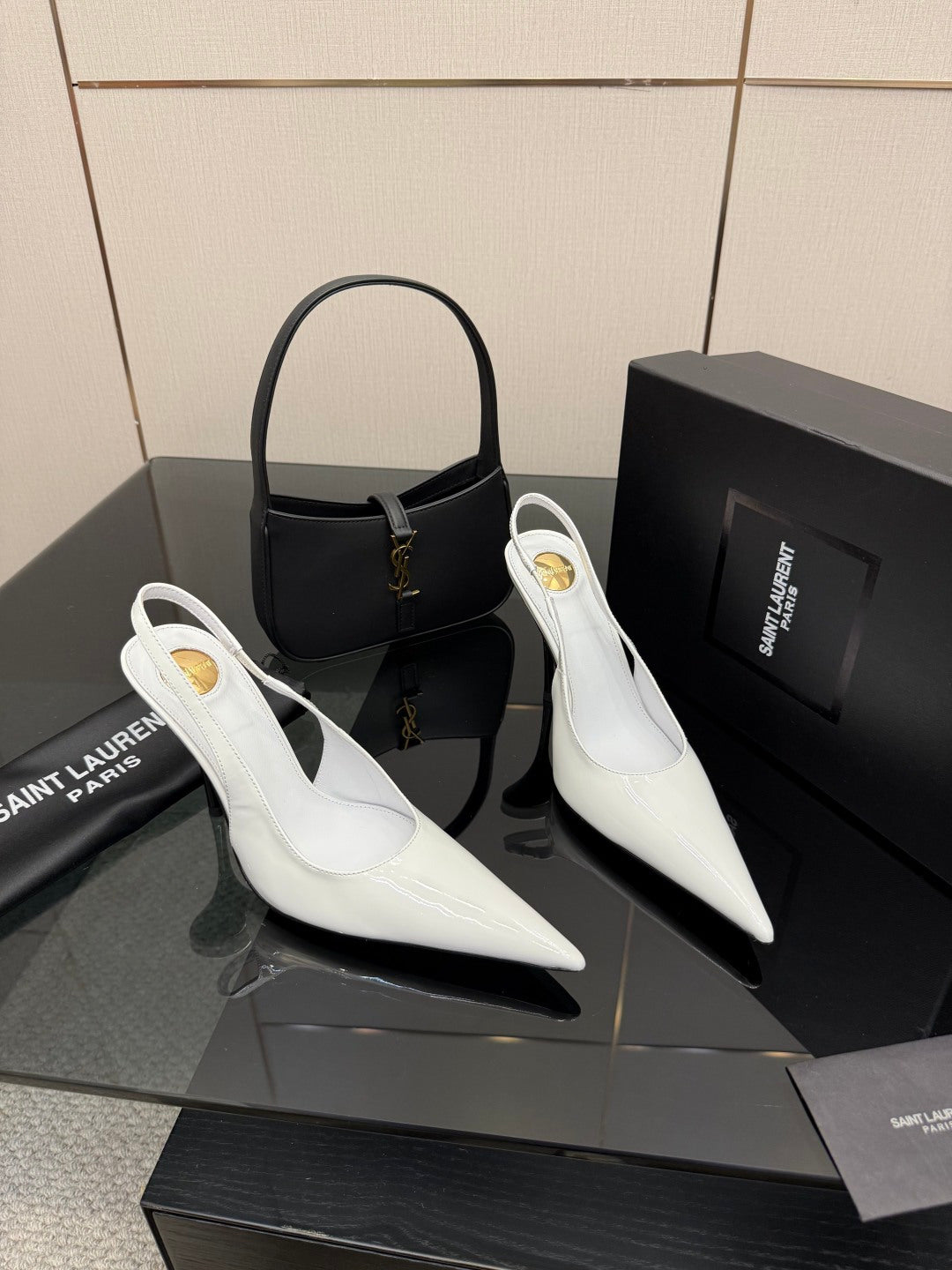 White pointed-toe slingback stiletto heels on display, slim high heel