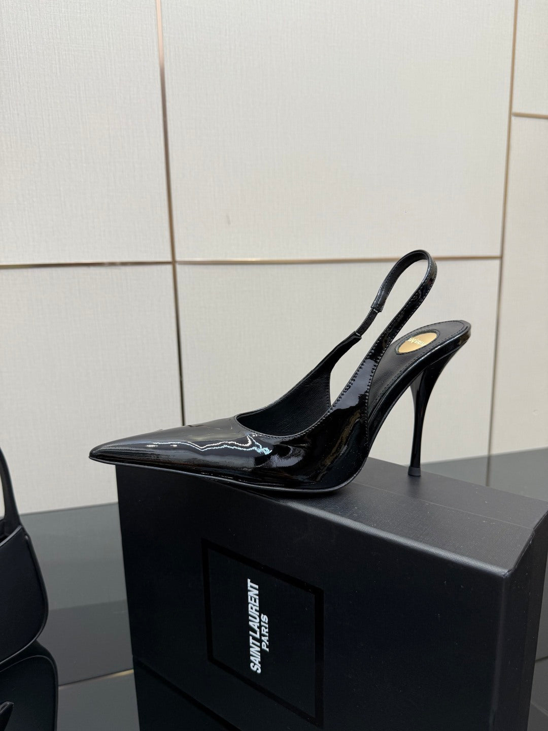Black patent slingback stiletto heel shoes with pointed toe and high heel