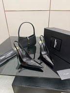 Black patent pointed-toe stiletto heels with slender high heel and ankle strap