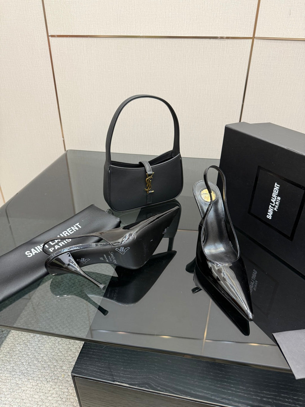 Black patent pointed-toe stiletto heels, glossy surface and ankle strap