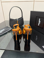 Orange patent pointed-toe slingback heels with slim stiletto heel, pair view