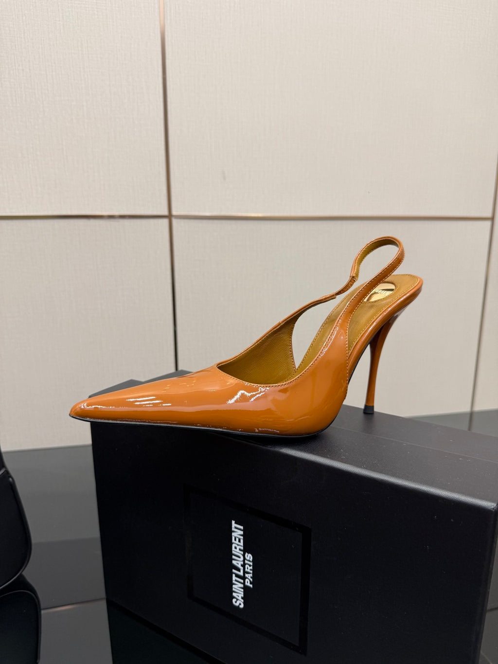 Orange patent mule-style pointed-toe heel with thin strap, slim stiletto