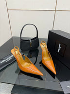 Orange patent pointed-toe slingback heels with slim stiletto heel, plus black top-handle bag