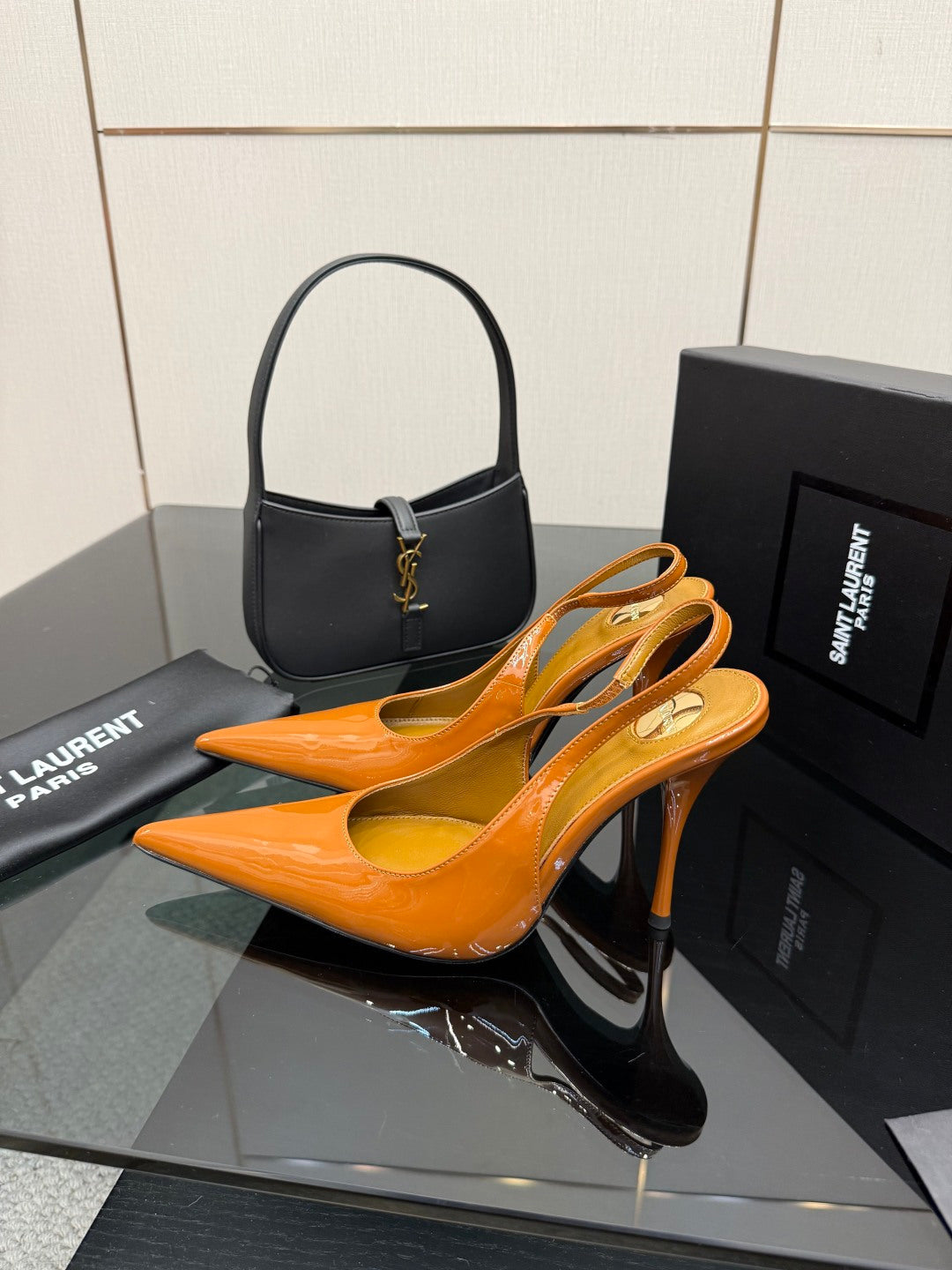 Orange patent slingback heels with slim stiletto heel, pointed toe