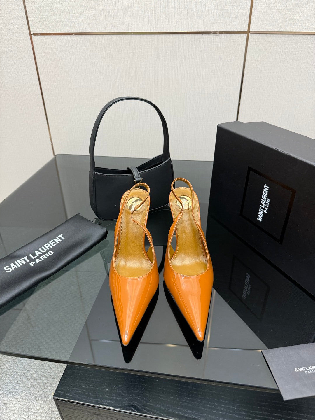 Orange patent pointed-toe high heels with slim stiletto heel and slingback strap