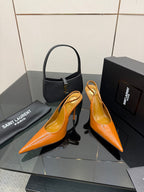 Orange patent pointed-toe slingback heels with slim stiletto heel, side view