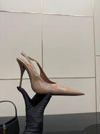 Nude patent leather pointed-toe slingback stiletto heels, side profile