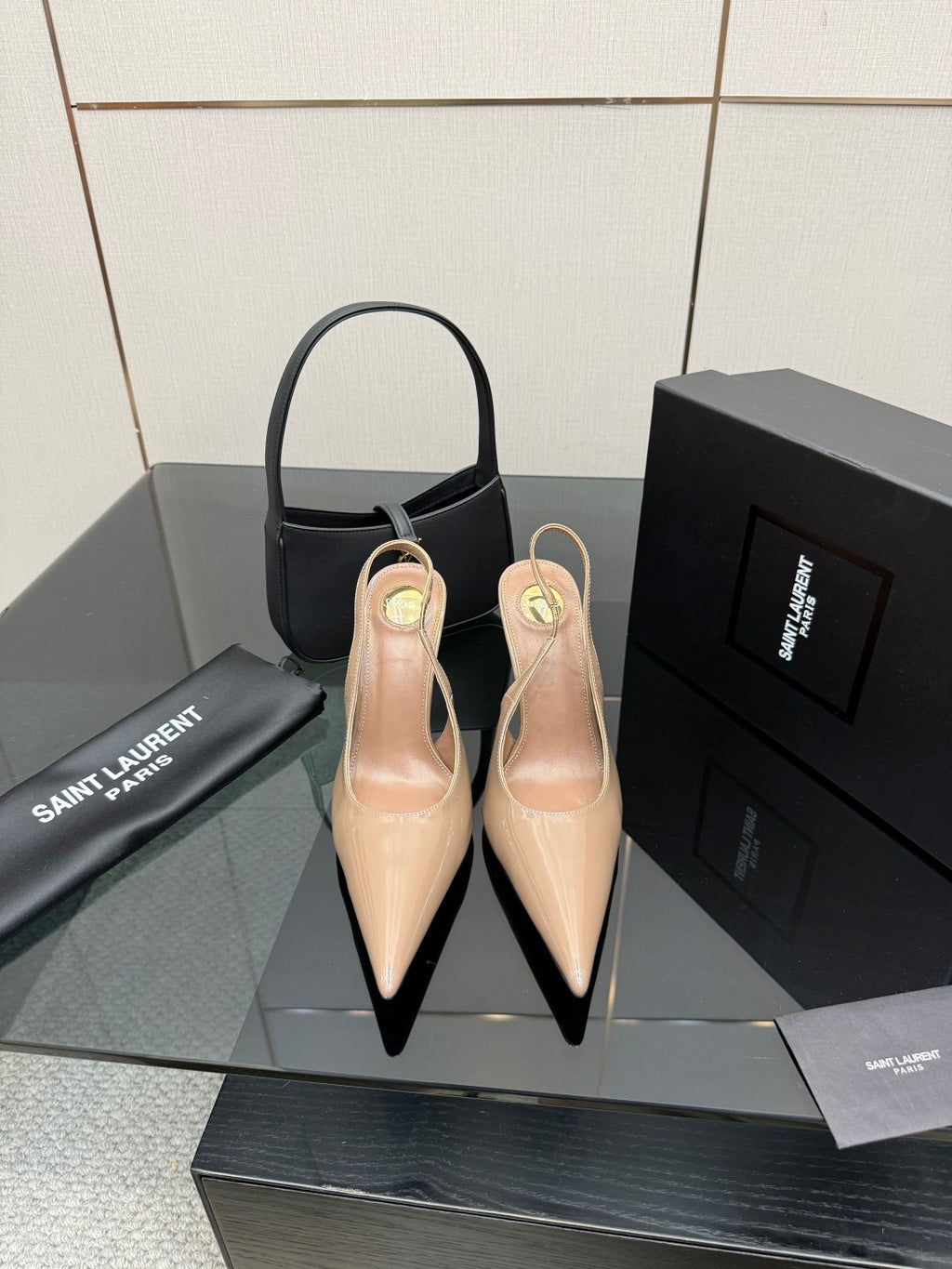 Nude patent leather pointed-toe stiletto heels with gold-tone YSL emblem, pair