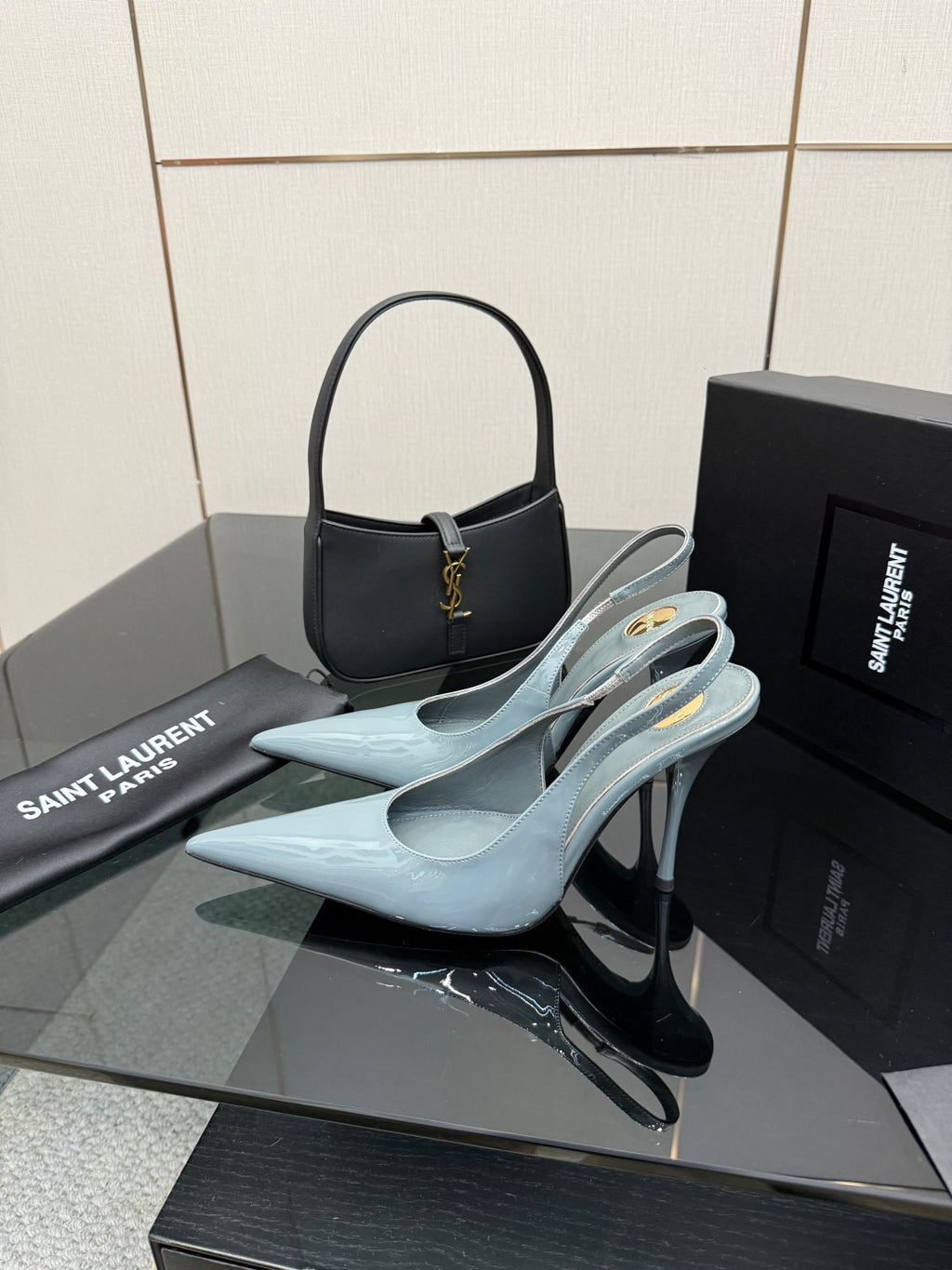 Light blue pointed-toe stiletto heels with thin ankle strap, glossy finish.