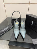 Light blue pointed-toe stiletto heels with slingback strap, glossy patent finish.